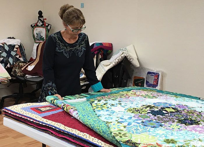 Cindy Seitz-Krug judging a quilt at a quilt show